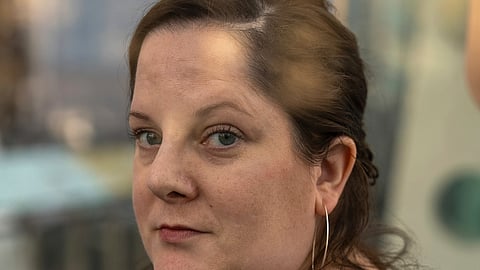 Emily Hollenbeck, a deep brain stimulation therapy patient being treated for depression, stands for a portrait at the American Museum of Natural History's Rose Center in New York.