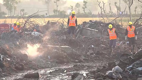 Rescue officials at the site of the firecrackers factory where an explosion and subsequent blaze on Tuesday killed at least 11 people and injured 174 others, in Harda district, Wednesday, Feb. 7, 2024.