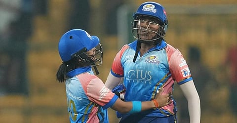 Mumbai Indians batters Sajeevan Sajana (right) and Amanjot Kaur celebrate the WPL 2024 match over Delhi Capitals, at the M Chinnaswamy Stadium in Bengaluru, Friday, Feb. 23, 2024.