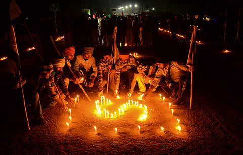 Farmers pay tribute to a farmer who was allegedly killed in Police action at Khanauri border amid their ongoing protest, during a candlelight vigil at the Punjab-Haryana Shambhu border, in Patiala district, Saturday, Feb. 24, 2024.