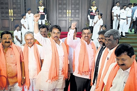 LoP R Ashoka, joined by other BJP MLAs, shouts slogans in the Assembly in Bengaluru on Monday.