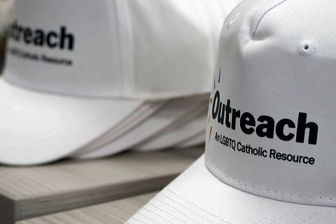 Branded hats displayed during the Outreach conference at Fordham University's Lincoln Center campus, New York, June 16, 2023.