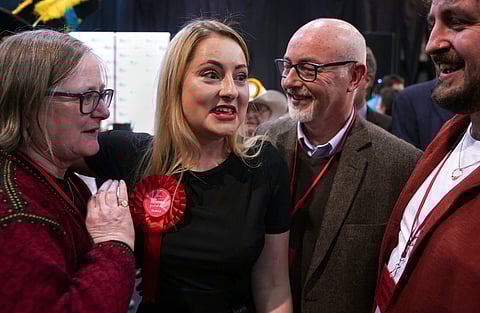 Labour Party candidate Gen Kitchen celebrates with her family after being declared winner in the Wellingborough by-election at the Kettering Leisure Village, Northamptonshire, Friday Feb. 16, 2024.