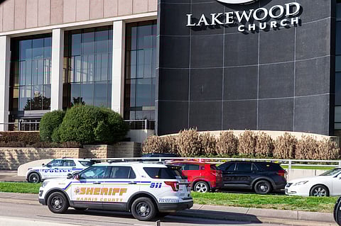 Emergency vehicles line the feeder road outside Lakewood Church during a reported active shooter event, Sunday, Feb. 11, 2024, in Houston.