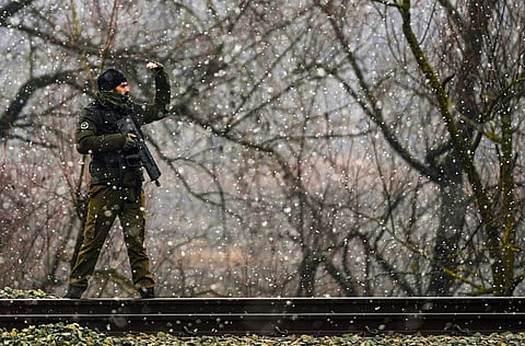 A security personnel stands guard near Srinagar railway station, in Jammu & Kashmir.