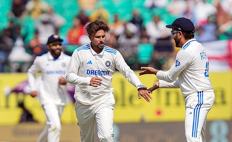 Kuldeep Yadav celebrates the wicket of England's Ben Stokes with captain Rohit Sharma (Photo | PTI)