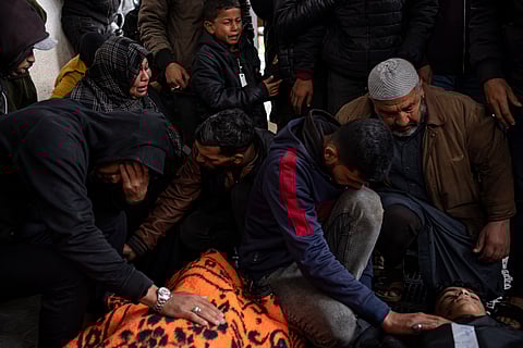 Palestinians mourn relatives killed in the Israeli bombardment of the Gaza Strip at a hospital morgue in Rafah.