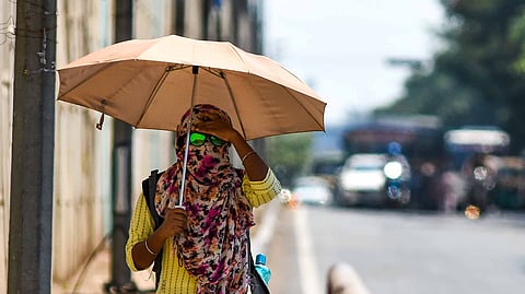 A woman walks with an umbrella to protect from heat in Bhubaneswar. (Photo | Debadatta Mallick, EPS)