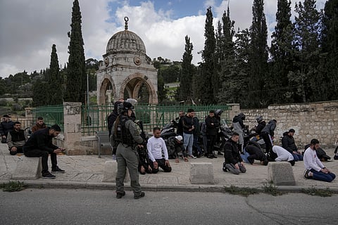 Palestinian Muslim worshipers who were prevented from entering the Al-Aqsa Mosque compound, pray outside Jerusalem's Old City,