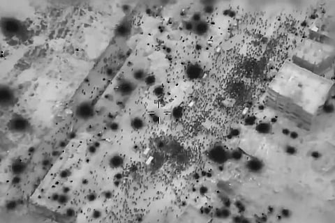 In this screen grab taken from video and released by the Israeli army on Thursday, Feb 29, 2024, Palestinians surround aid truck in northern Gaza in what officials described the day before as the first major delivery in a month.