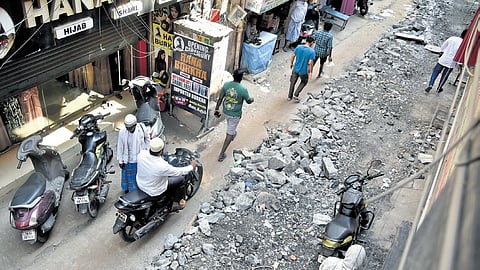 Pedestrians and vehicles moving along the heavily dug-up Angappa Naicken Street in George Town, one of the busiest streets in the locality