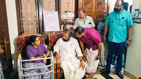 General Education Minister V Sivankutty talking to Sandhya Rani, a school teacher who lost her leg in an accident involving a tipper, at her house in Kalluvettankuzhi, Venganoor