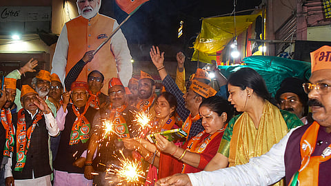 BJP workers celebrate the announcement of Prime Minister Narendra Modi contesting from Varanasi for the third time after BJP released its first list of candidates for the upcoming Lok Sabha elections, in Varanasi, Saturday, March 2, 2024.