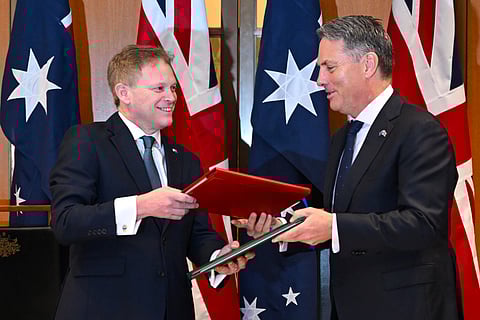 Secretary of State for Defence of the United Kingdom Grant Shapps, left, and Australian Defence Minister Richard Marles exchange a new defence and security cooperation agreement at Parliament House at Parliament House in Canberra, Thursday, March 21, 2024.