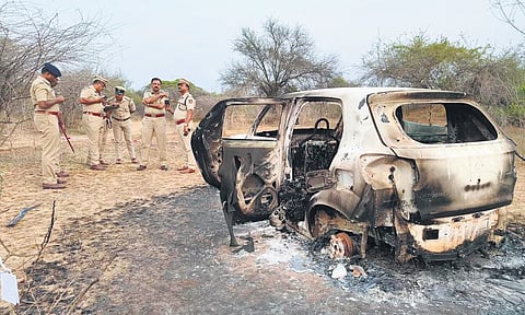 Senior police officials inspect the crime scene at the Kunchangi tank bed near Tumakuru on Friday