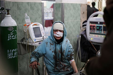 A Palestinian wounded in the Israeli bombardment sits in a hospital In Rafah, Gaza Strip, Saturday, Feb. 10, 2024.