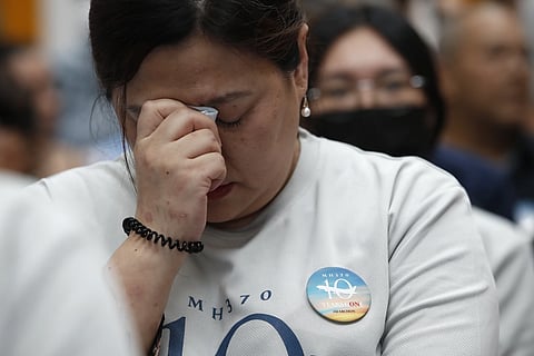 A family member of passengers on board of the missing Malaysia Airlines Flight 370 cries during the tenth annual remembrance event at a shopping mall in Subang Jaya on the outskirts of Kuala Lumpur, March 3, 2024.