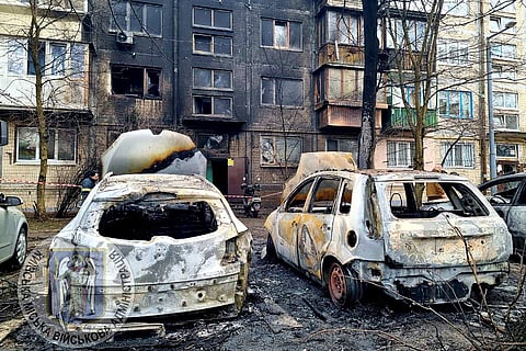 Burned cars are seen at the site where Russian missiles hit Ukraine's Kyiv.