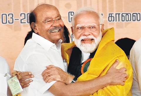 Prime Minister Narendra Modi greets PMK founder S Ramadoss during a public meeting at Salem on Tuesday.