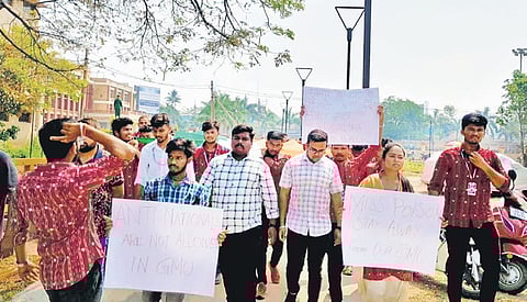 Agitating students shouting slogans asking Menon to leave GMU campus