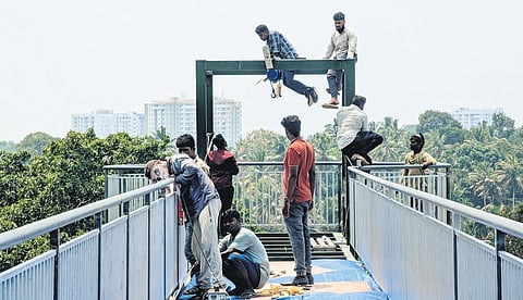 Workers giving finishing touches to the glass bridge that will be opened for the public next week at Akkulam Tourist Village in Thiruvananthapuram