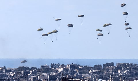 In this picture taken from Israel’s southern border with the Gaza Strip shows humanitarian aid being airdropped over the Palestinian territory on March 10, 2024.
