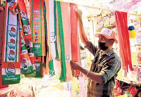 Shawls with colours of various parties on display at a shop in Kochi