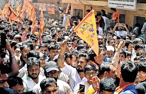 Hindu activists take out a protest rally demanding the arrest of all those who assaulted a shopkeeper, in Bengaluru on Tuesday