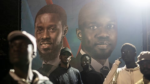 Supporters of presidential candidate Bassirou Diomaye Faye and Senegal's top opposition leader, Ousmane Sonko, gather outside their campaign headquarters as they await the results of the presidential election, in Dakar, Senegal, Sunday, March 24, 2024