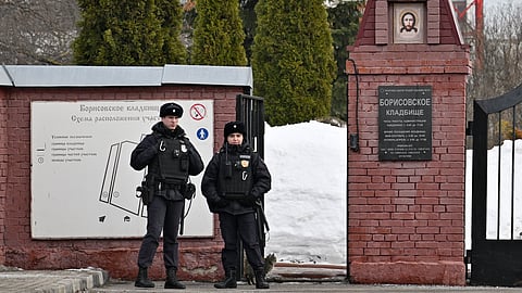 Police officers stand guard at the Borisovskoye Cemetery where the funeral of Russian opposition leader Alexei Navalny will be held on Friday.