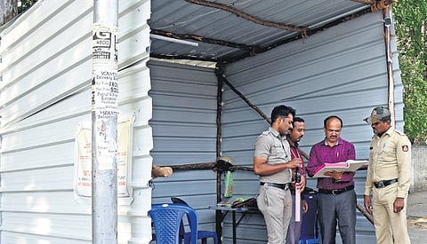 Election Duty staff at checkpost working under a Tin Sheet sheds , its difficult to work under the sheet summer heat , in Bengaluru on Wedesday