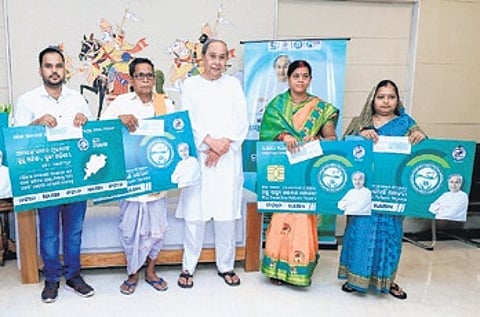Chief Minister Naveen Patnaik with the beneficiaries of BSKY Nabin card in Bhubaneswar on Wednesday | Express