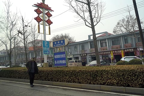 A man walks along the road in the city of Handan in northern China's Hebei province, where a 13 year boy was brutally killed, allegedly by his classmates.