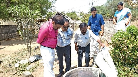 Officials inspect a underground water tank in Indugula village on Thursday