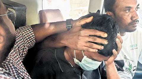 Officials detain the suspect in Madurai on Friday