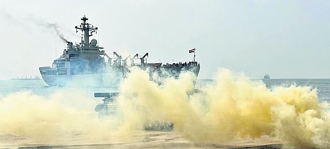 Amphibious vehicles land on Kakinada Beach as part of Tiger Triumph 2024; (inset) defence officials witnessing the exercise