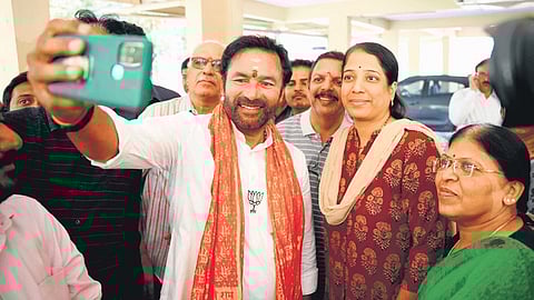 BJP state president G Kishan Reddy takes a selfie with his supporters during his visit to Srinagar Colony in Hyderabad on Tuesday