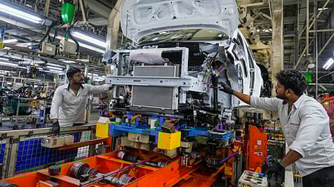 Employees work in an assembly line at the joint manufacturing facility of Renault-Nissan Automotive India Pvt Ltd, near Chennai.