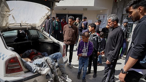 Palestinians killed in an Israeli airstrike are brought into Shifa Hospital in Gaza City on Friday.