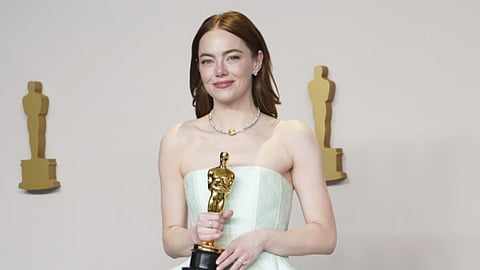 Emma Stone poses in the press room with the award for best performance by an actress in a leading role for "Poor Things" at the Oscars on Sunday, March 10, 2024, at the Dolby Theatre in Los Angeles.