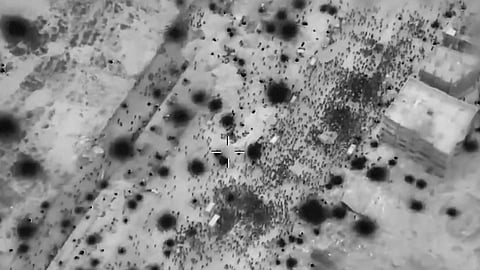 Palestinians surround aid trucks in northern Gaza in what officials described the day before as the first major delivery in a month.