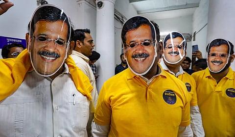 AAP MLAs wear masks of Chief Minister Arvind Kejriwal during their protest against CM's arrest, at the Delhi Legislative Assembly.