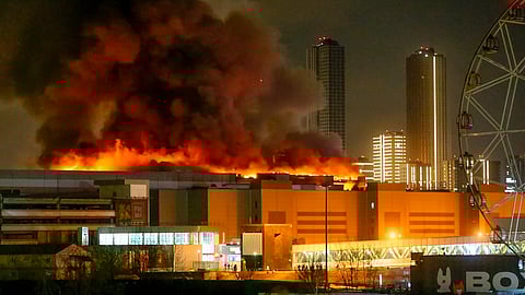 A massive blaze is seen over the Crocus City Hall on the western edge of Moscow, Russia, Friday, March 22, 2024.