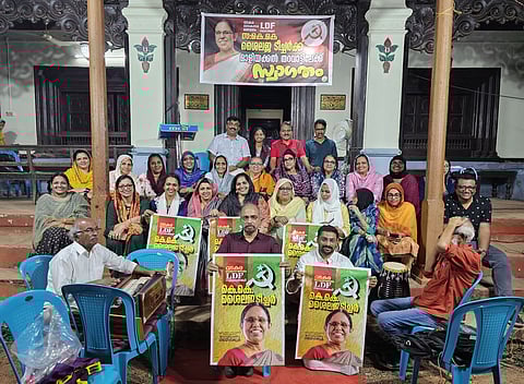 Maliyekkal family members hold posters during an event to welcome CPM Vadakara Lok Sabha candidate K K Shailaja at their ancestral house.