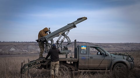 Ukrainian soldiers from The 56th Separate Motorized Infantry Mariupol Brigade prepare to fire a multiple launch rocket system based on a pickup truck towards Russian positions at the front line