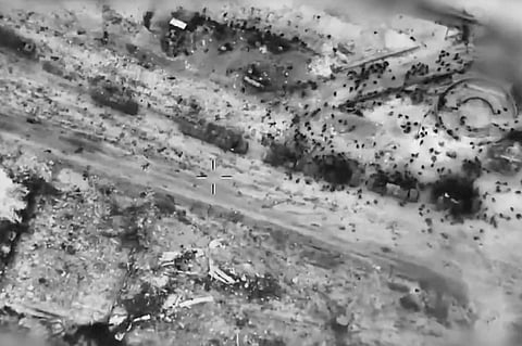 In this screen grab taken from video and released by the Israeli army on Thursday, Feb. 29, 2024, Palestinians surround aid trucks in northern Gaza.