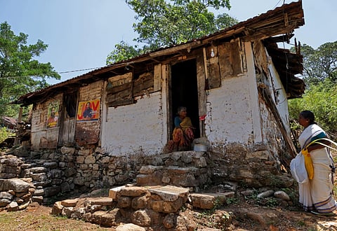 2 years old Mookkamma and her sister Sarojam in front of her house at Bonacaud Estate in Thiruvananthapuram.