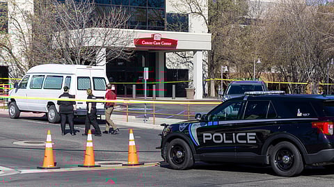 A police vehicle is parked outside Saint Alphonsus Regional Medical Center in Boise, Idaho, where an escaped jail inmate and accomplice shot at police officers.