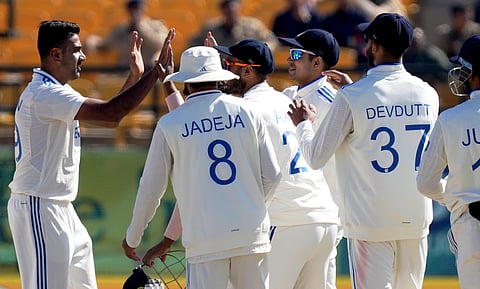 India's Ravichandran Ashwin (L) with teammates celebrates the wicket of England's Zak Crawley during the 3rd day of the fifth Test cricket match between India and England on March 9, 2024.