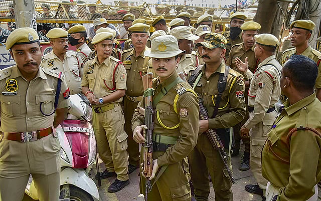 Security personnel stand guard during a protest after the Ministry of Home Affairs notified the rules for implementation of the Citizenship (Amendment) Act, outside Rajiv Bhawan in Guwahati.